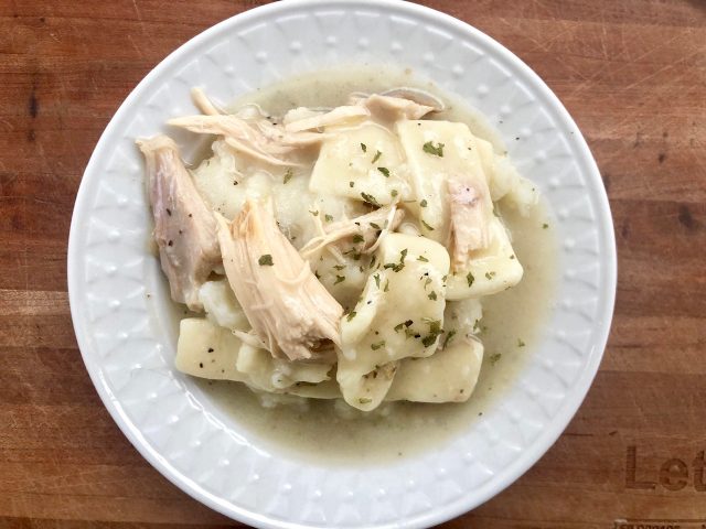 Creamy Chicken and Homemade Noodles -- Tender chicken floats in creamy gravy and homemade noodles served over mashed potatoes. This is comfort food at its finest. | thatwhichnourishes.com