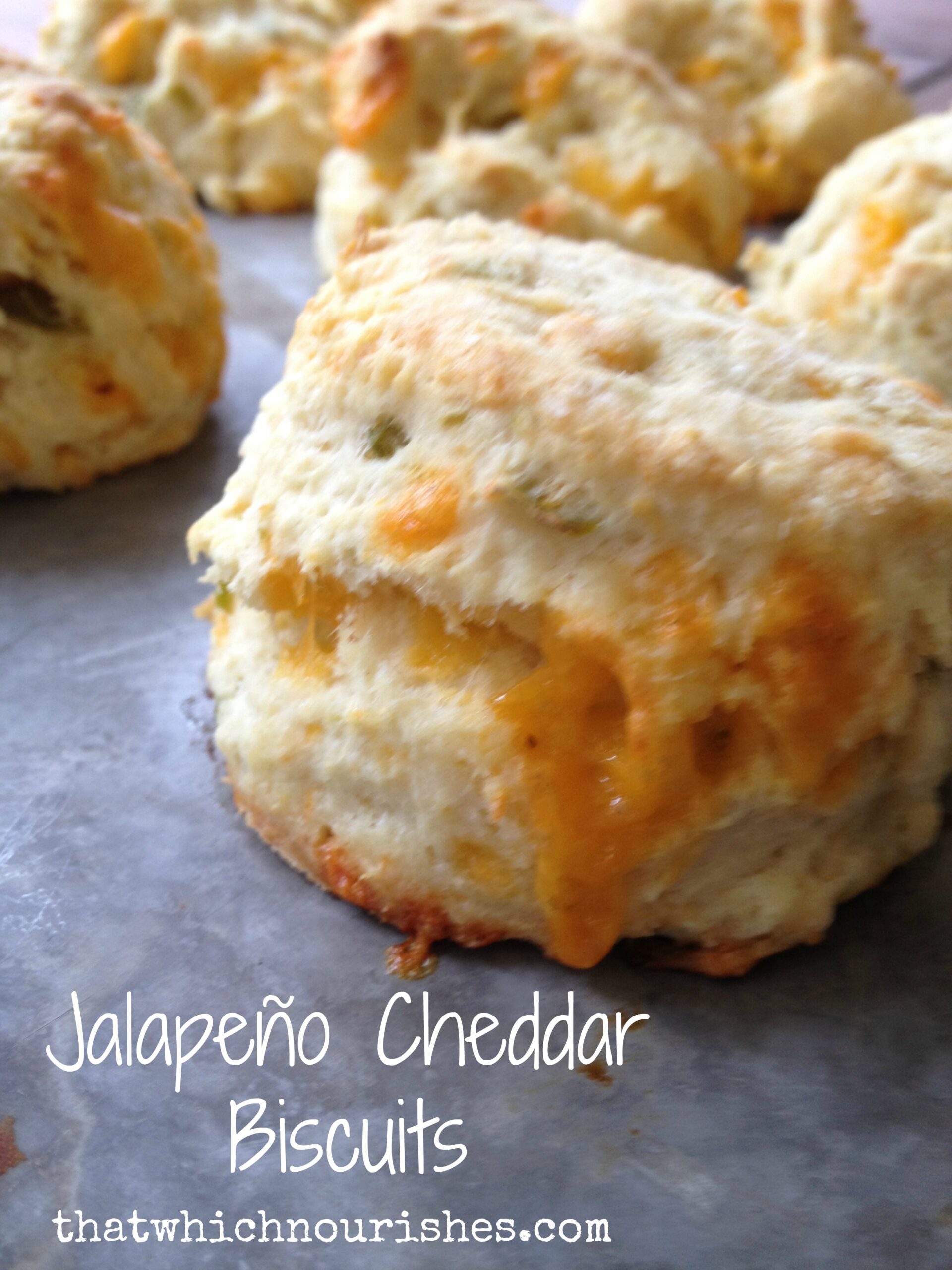 Jalapeño Cheddar Biscuits -- Fluffy, buttery, cheesy bites of yum with goozey cheese and a kick of spice with bits of jalapeños. Spicy, buttery, perfectly fluffy biscuits. | thatwhichnourishes.com