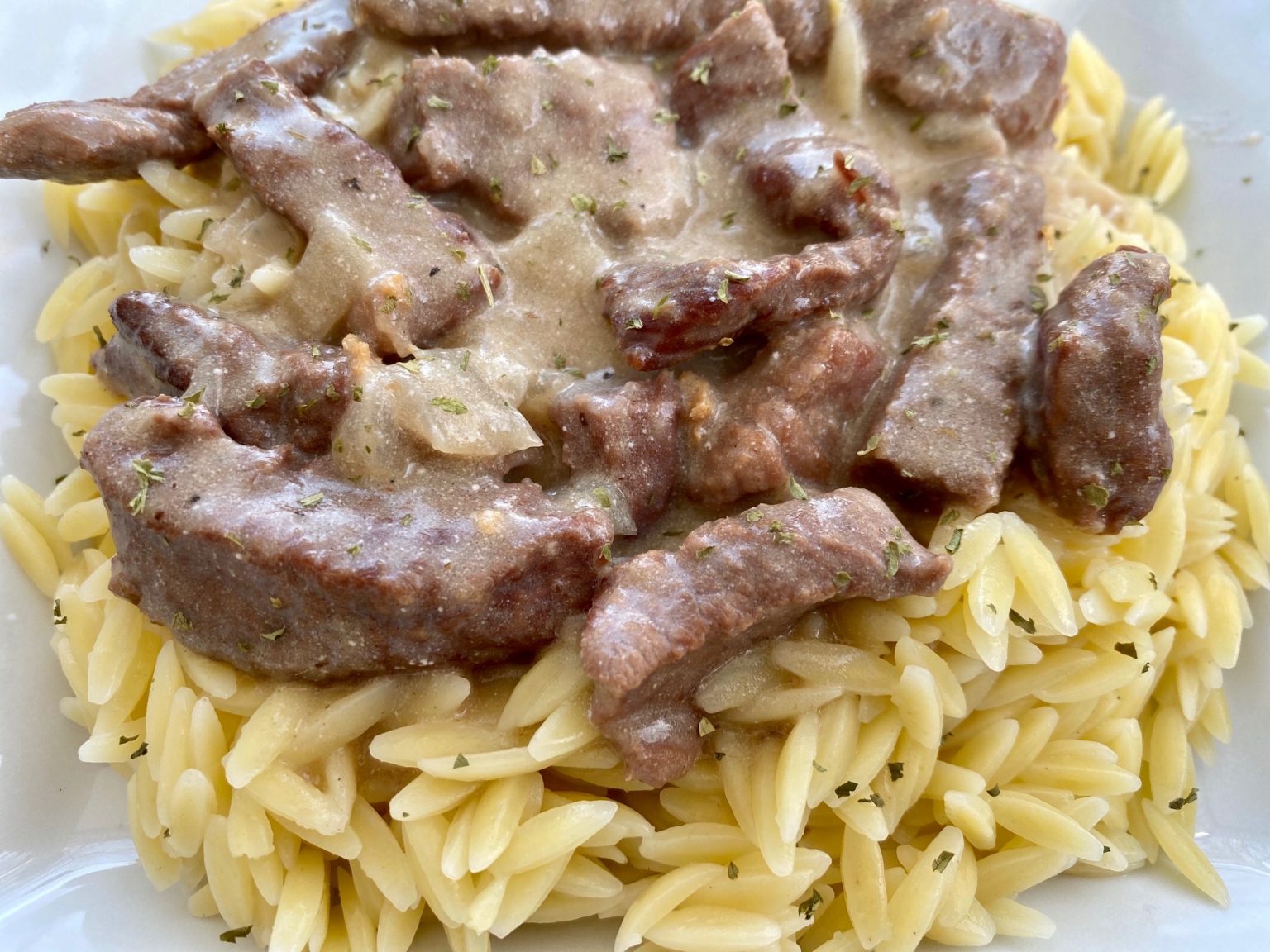 Savory Beef Stroganoff -- Tender strips of beef swimming in a rich and 