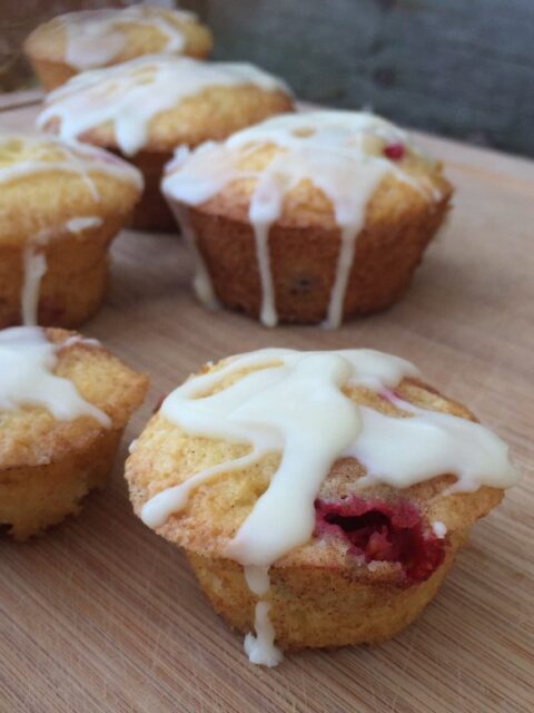 Cranberry Orange muffins -- A sweet, fluffy, orange-y muffin with little bursts of tart cranberry, covered with a tangy sweet orange glaze or orange sugar. | thatwhichnourishes.com