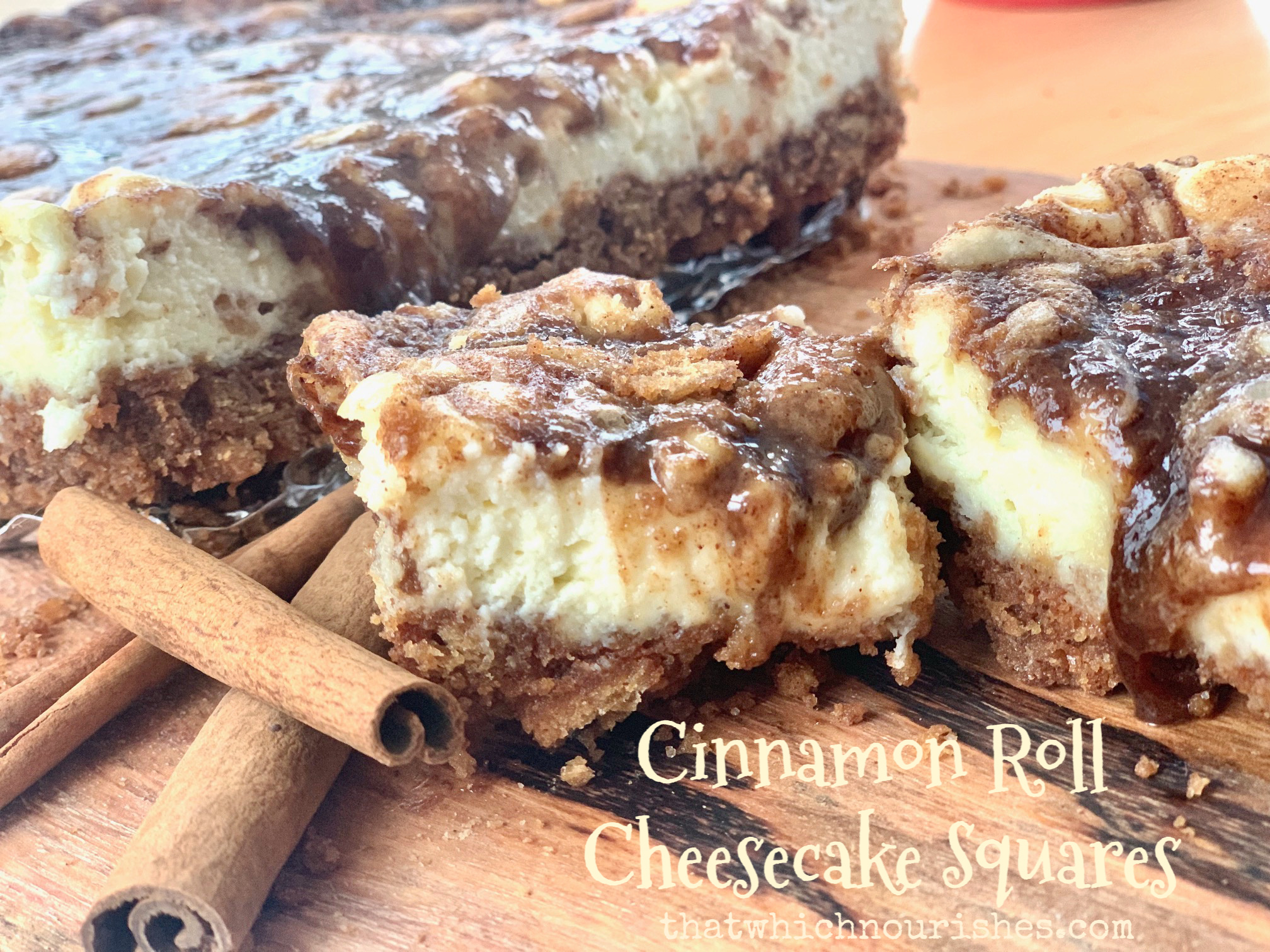Cinnamon Roll Cheesecake Squares -- Goozy cinnamon roll filling draped and dripping from atop perfectly creamy little squares of cheesecake. These are all of the cinnamon-roll-love without the work! | thatwhichnourishes.com
