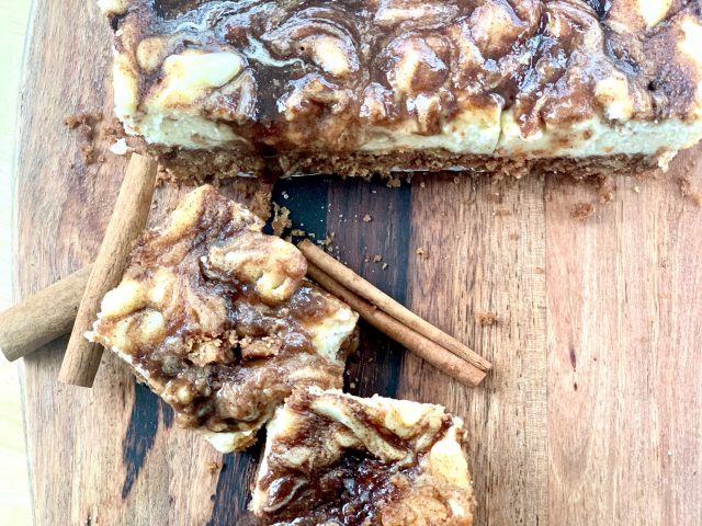 Cinnamon Roll Cheesecake Squares --Goozy cinnamon roll filling draped and dripping from atop perfectly creamy little squares of cheesecake. These are all of the cinnamon-roll-love without the work! | thatwhichnourishes.com