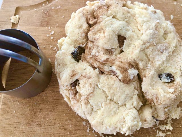 Glazed Cinnamon Raisin Biscuits -- Tender, flaky, buttery biscuits made from scratch, studded with plump raisins, and flavored with cinnamon -- finished off with a drizzle of sweetness. | thatwhichnourishes.com